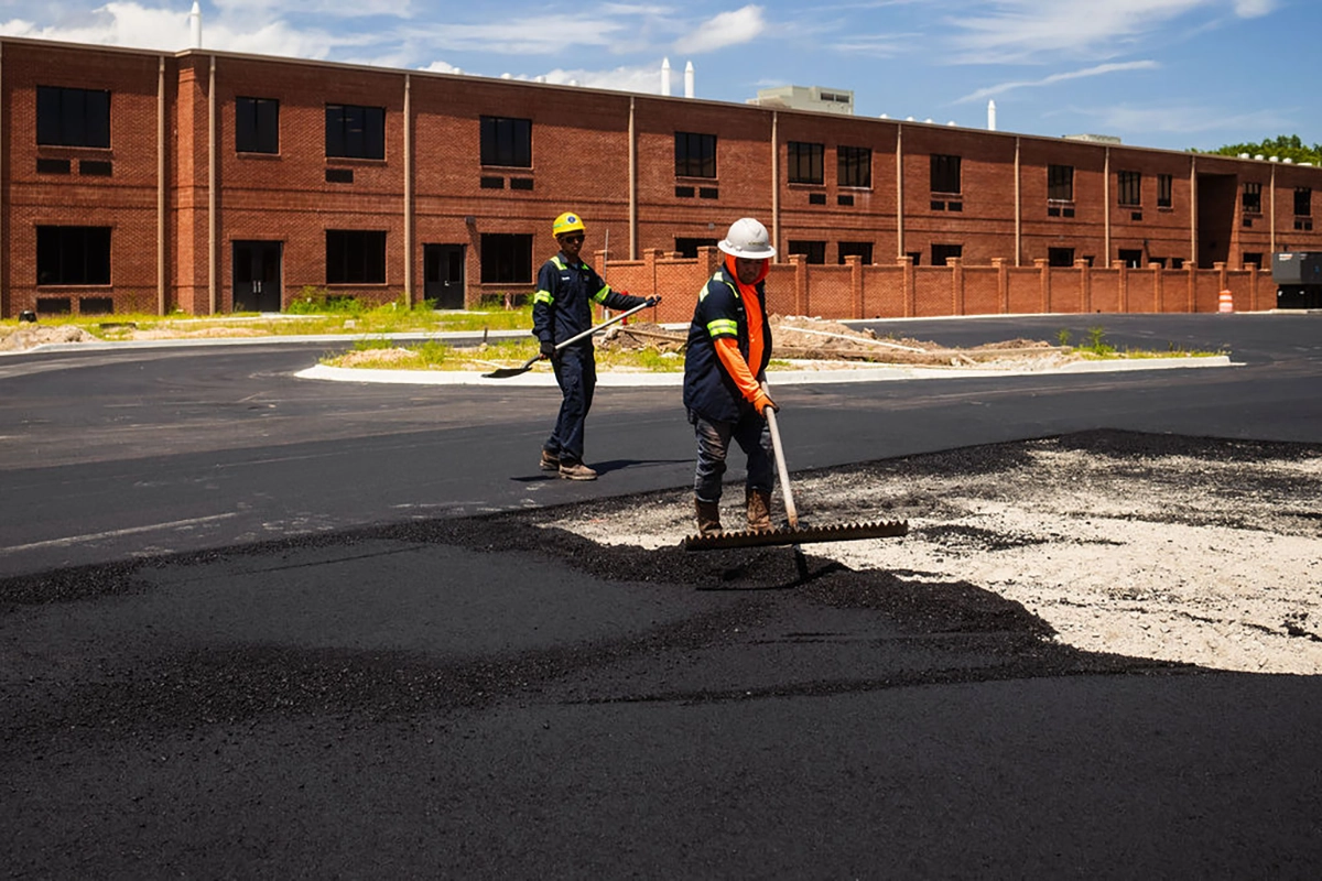 pave america employees raking asphalt